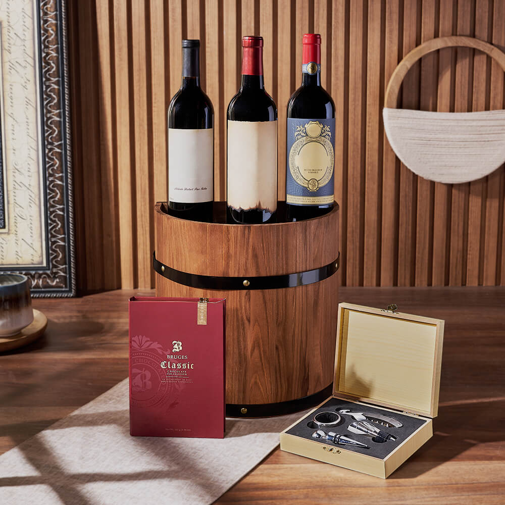 three wines on a barrel with chocolate book box and wine tool kit